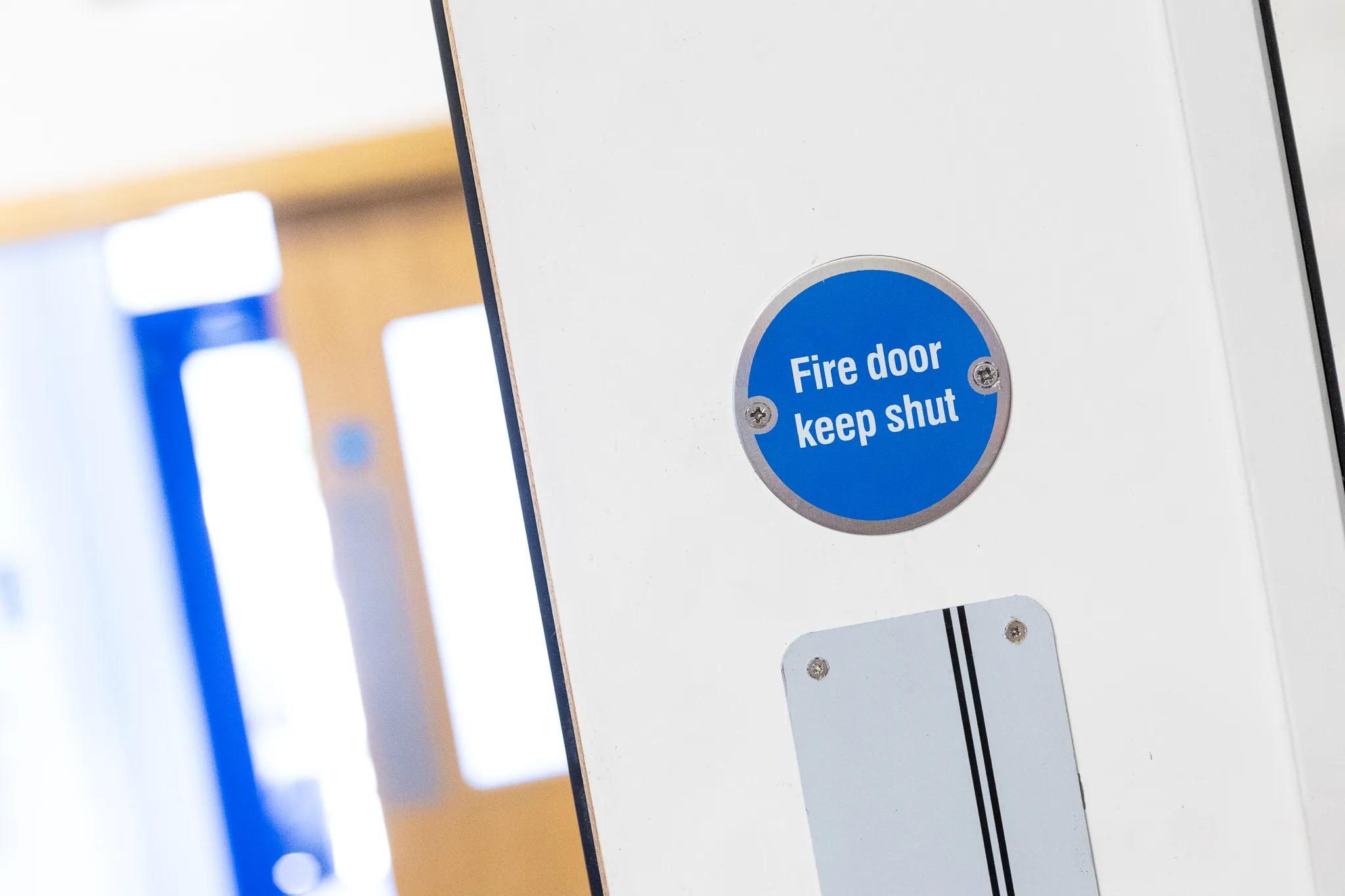A 'Fire door keep shut' sign on a fire door