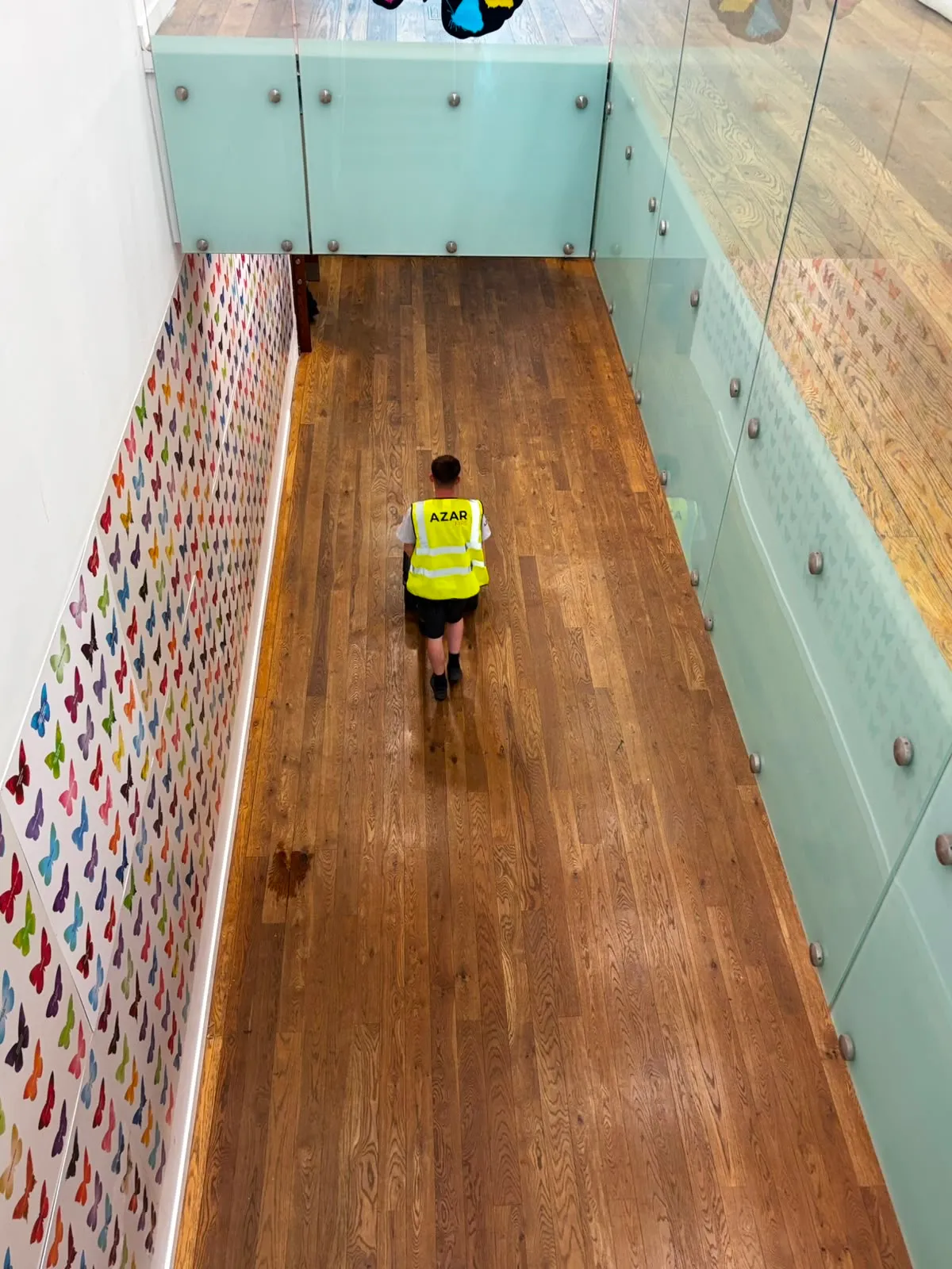 Museum corridor with a glazed balustrade and gallery displays