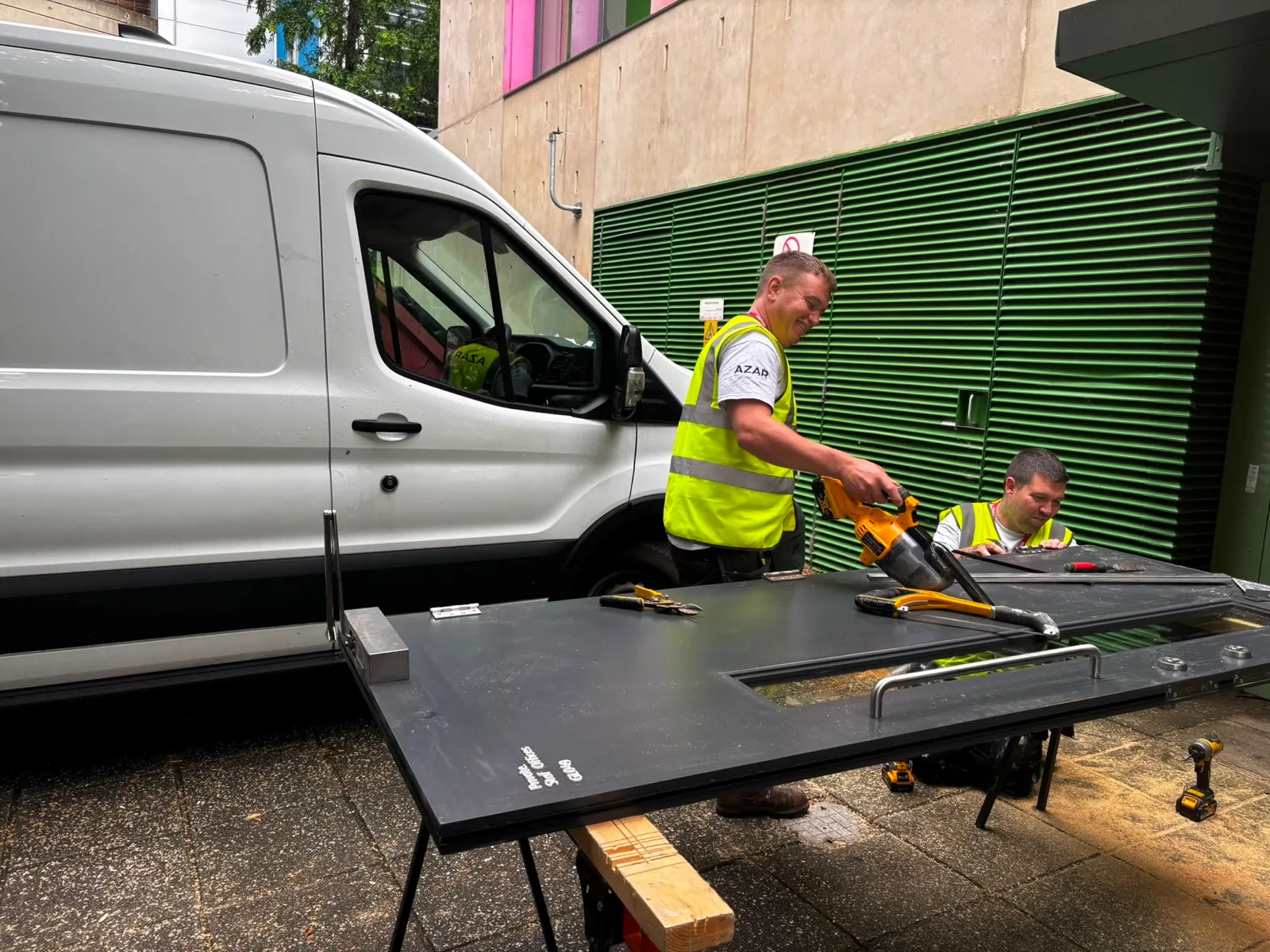 Azar Fire operatives preparing a fire door on site at the museum