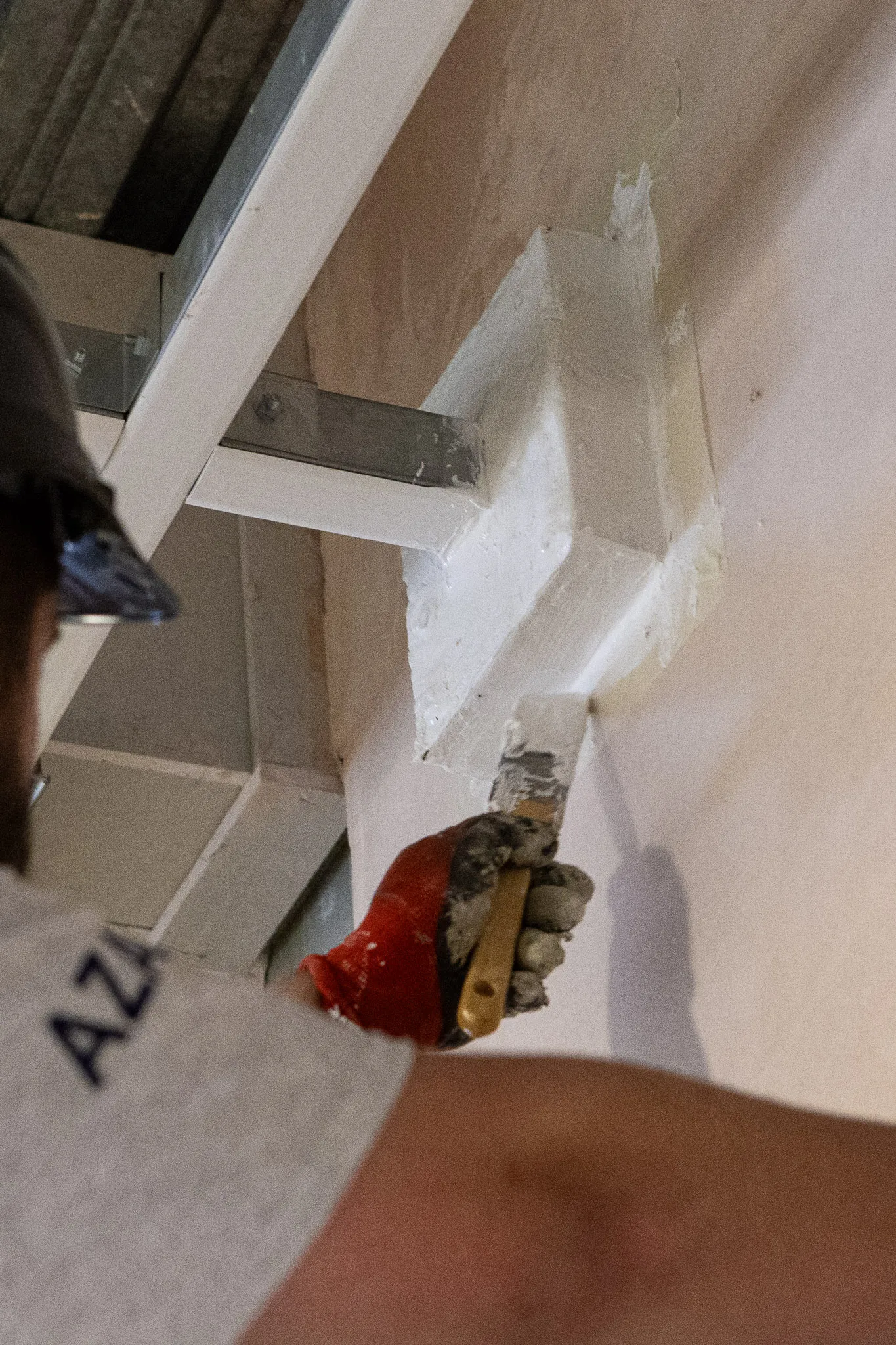 Azar Fire operative applying fire-stopping sealant around a structural steel penetration