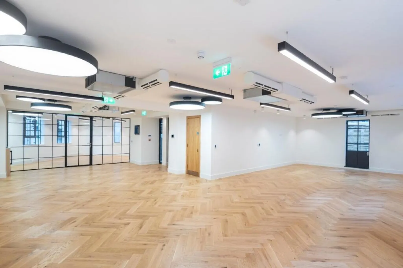 A CAT A+ office refurbishment with herringbone oak flooring and a glazed partition